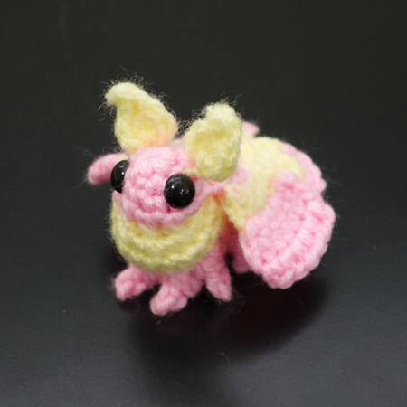 a tiny crochet rosy maple moth