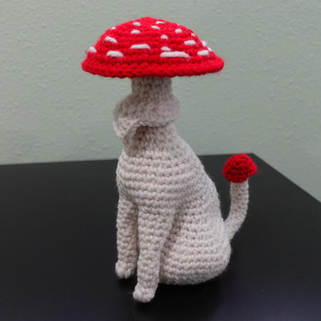 Untitled a crochet creature with the head of a mushroom cat and the body of a cat